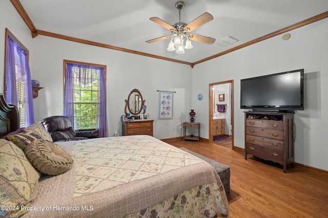 bedroom with ceiling fan, connected bathroom, light hardwood / wood-style flooring, and ornamental molding