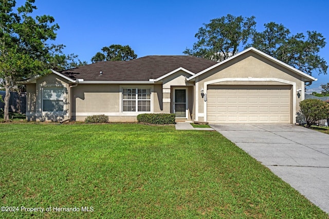 single story home featuring a garage and a front lawn