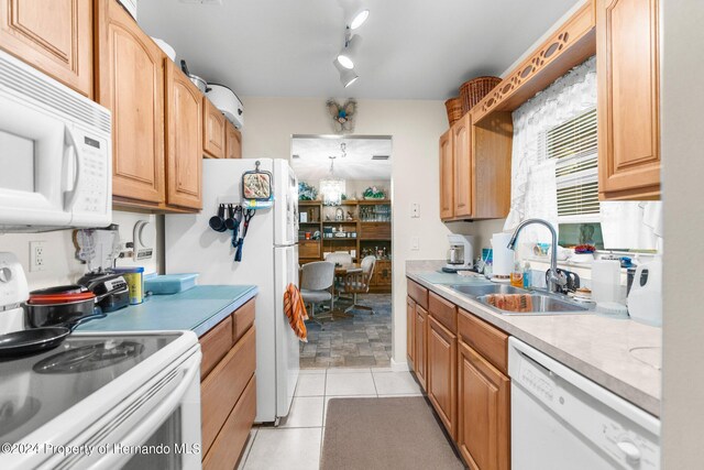 3391 Lambert Ave, Spring Hill, FL 34608 - kitchen with white appliances, sink, and light tile patterned flooring