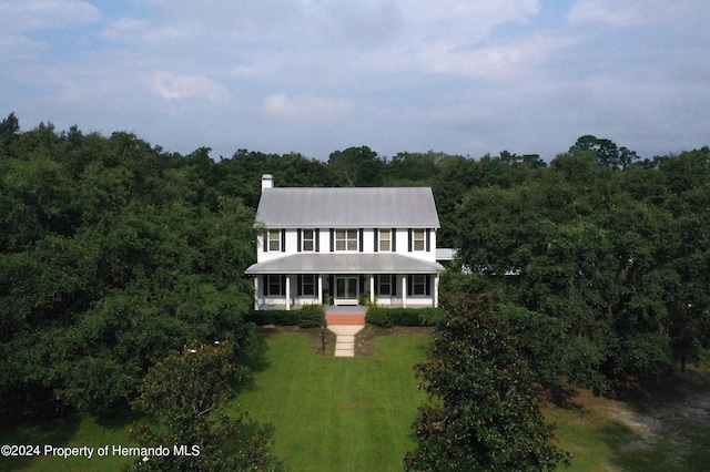 view of front of house featuring a front lawn and covered porch