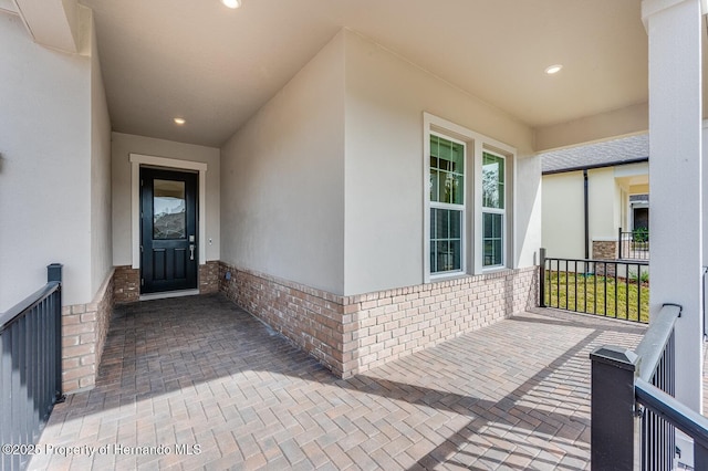 view of exterior entry with covered porch