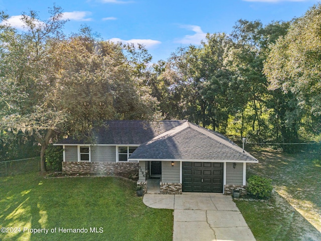 view of front of home with a front lawn and a garage