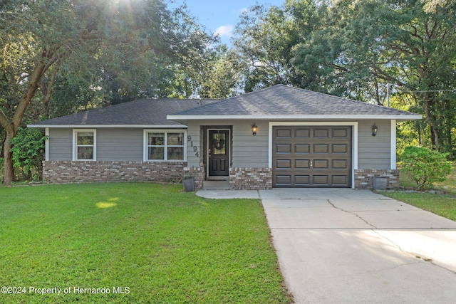 ranch-style house with a garage and a front yard