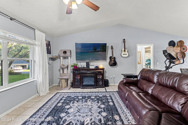 living room featuring ceiling fan, light tile patterned floors, and lofted ceiling