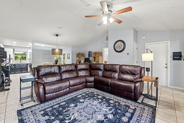 living room featuring light tile patterned floors, ceiling fan, and vaulted ceiling