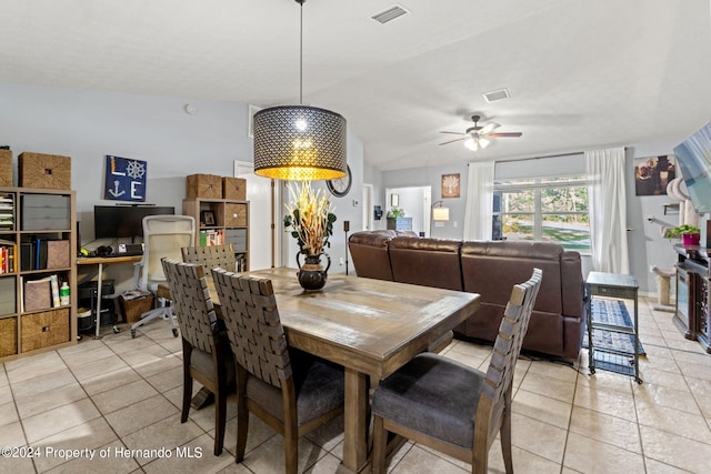 tiled dining room featuring ceiling fan and vaulted ceiling