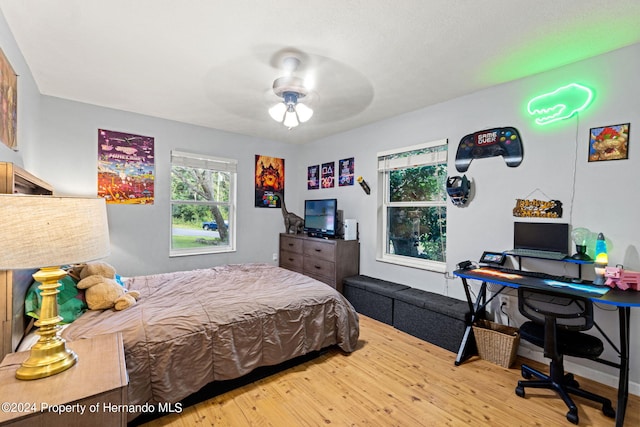 bedroom with hardwood / wood-style flooring and ceiling fan