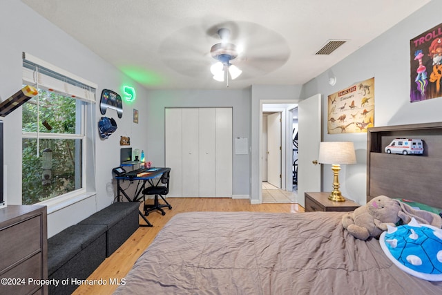 bedroom featuring a closet, ceiling fan, and light hardwood / wood-style flooring