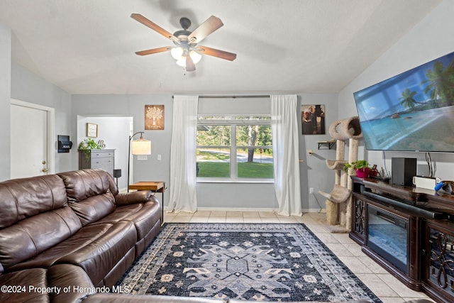 tiled living room featuring a textured ceiling, ceiling fan, and vaulted ceiling