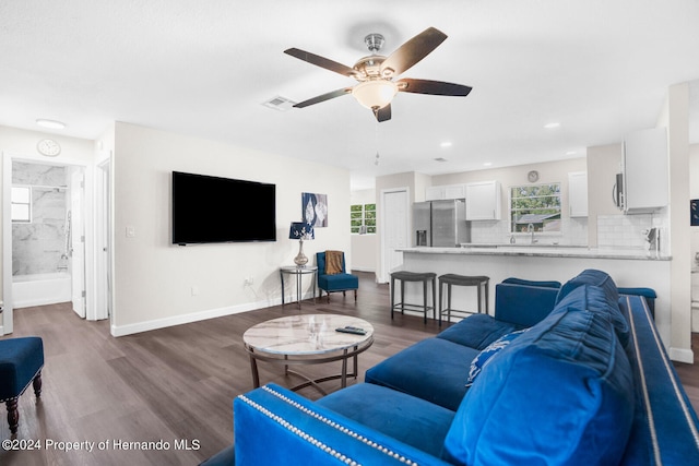 living room with dark hardwood / wood-style floors and ceiling fan