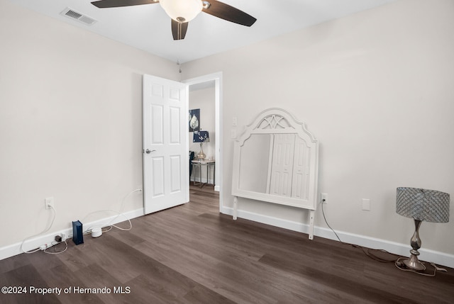 spare room featuring ceiling fan and dark hardwood / wood-style floors