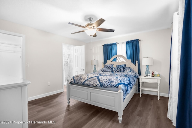 bedroom featuring dark wood-type flooring, ceiling fan, connected bathroom, and a closet