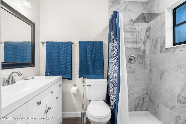 bathroom featuring walk in shower, vanity, and toilet