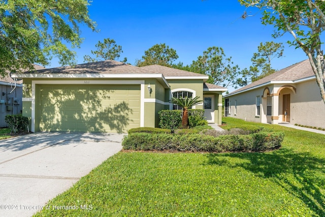 view of front of house with a front yard and a garage