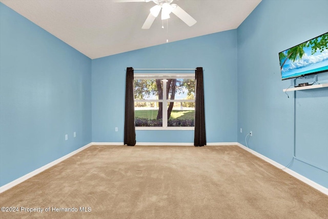 unfurnished room featuring ceiling fan, light colored carpet, and vaulted ceiling