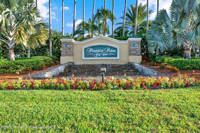 community sign featuring a lawn