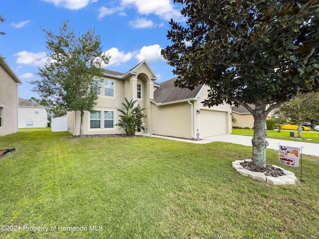 view of front of house with a front lawn and a garage