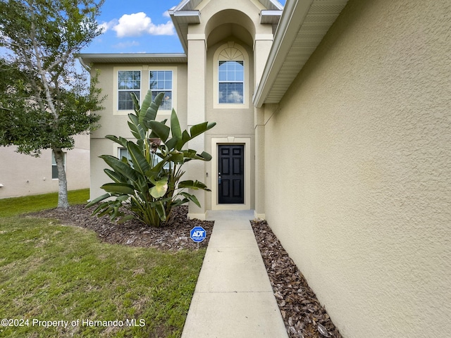 entrance to property with a yard