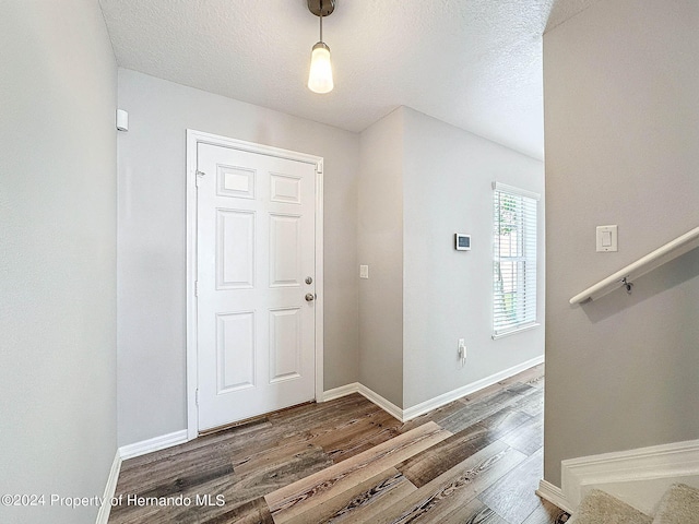 foyer with hardwood / wood-style floors and a textured ceiling