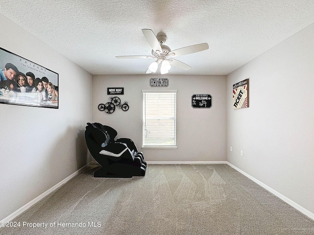 unfurnished room featuring ceiling fan, a textured ceiling, and carpet floors