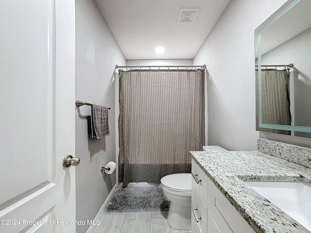 full bathroom with tile patterned flooring, vanity, toilet, and shower / bath combination with curtain