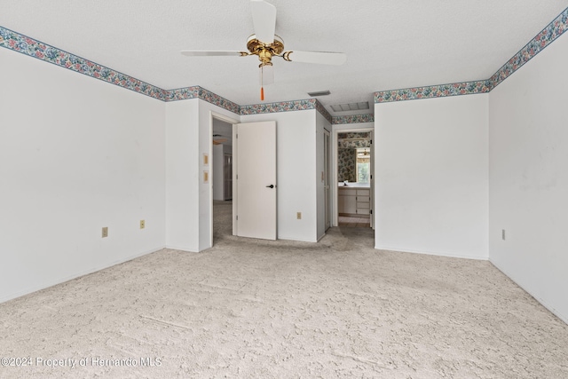 unfurnished bedroom featuring a textured ceiling, light carpet, and ceiling fan