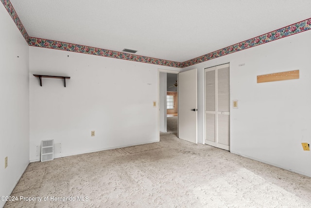 unfurnished room featuring a textured ceiling