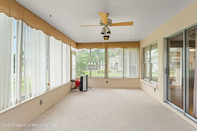 sunroom with ceiling fan and plenty of natural light