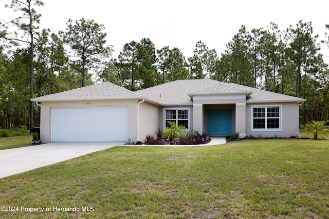 view of front of house featuring a garage and a front lawn