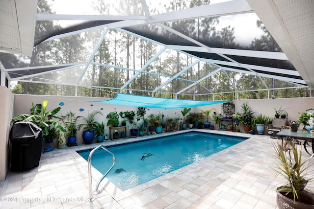 view of swimming pool with glass enclosure and a patio area