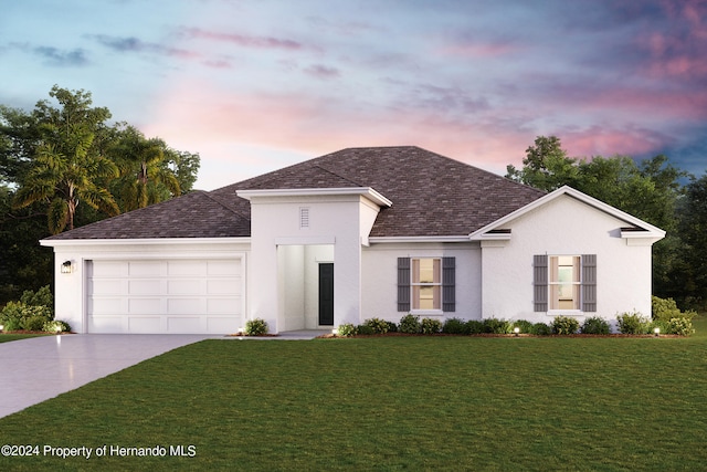 view of front facade with a garage and a yard