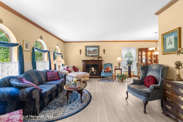 living room with light wood-type flooring, a chandelier, and crown molding