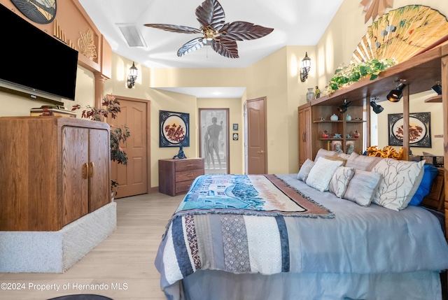 bedroom with ceiling fan and light hardwood / wood-style floors