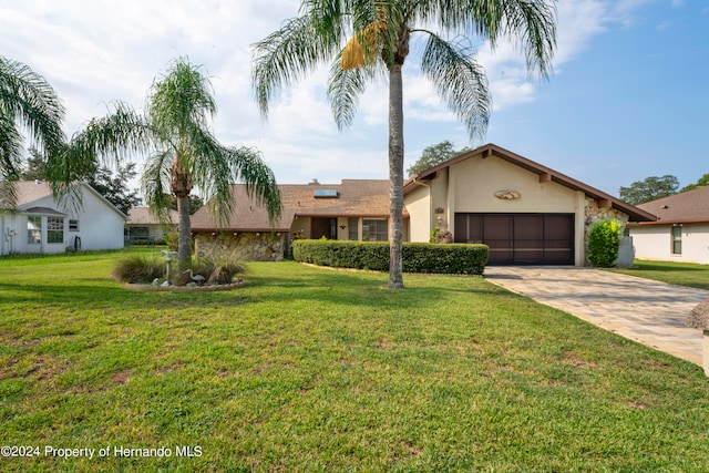 view of front of property with a garage and a front yard