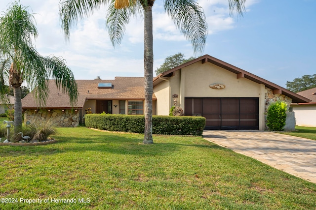 view of front of home featuring a garage and a front lawn