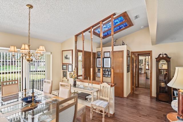 dining space featuring dark wood-type flooring, an inviting chandelier, vaulted ceiling, and a textured ceiling