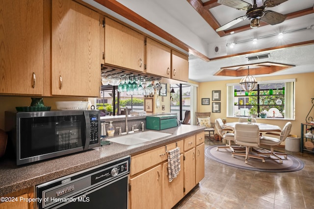 kitchen featuring ceiling fan with notable chandelier, dishwasher, sink, a tray ceiling, and light brown cabinets