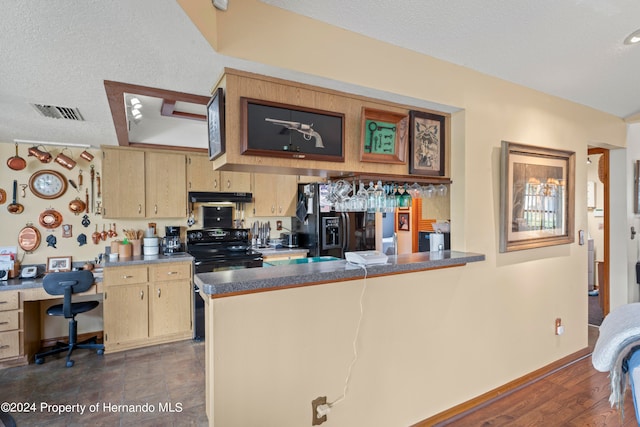 kitchen featuring a textured ceiling, kitchen peninsula, black appliances, and dark hardwood / wood-style floors