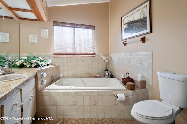 bathroom with toilet, vanity, tile patterned floors, and a relaxing tiled tub