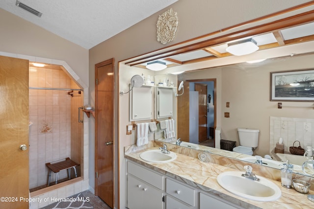 bathroom featuring lofted ceiling, toilet, tile patterned flooring, a textured ceiling, and vanity