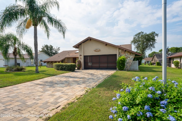 single story home with a garage and a front yard