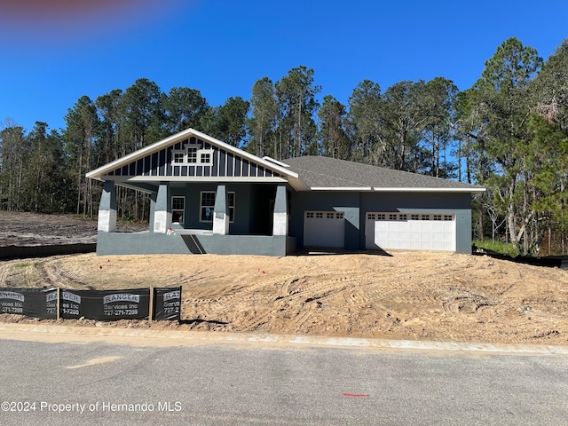 view of front of house with a porch and a garage