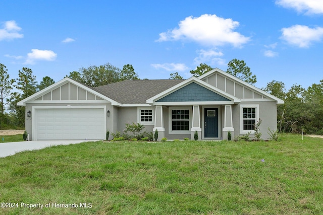 view of front of house with a garage and a front lawn