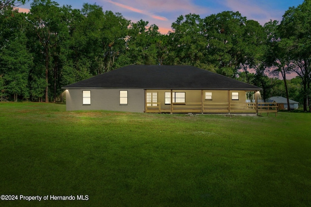 back house at dusk with a yard