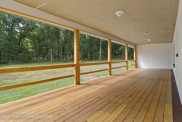 wooden deck with a lawn