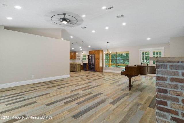 recreation room featuring ceiling fan with notable chandelier, pool table, light wood-type flooring, and lofted ceiling