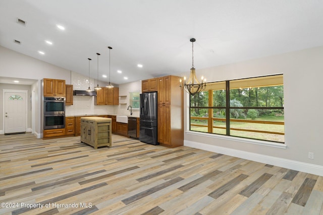 kitchen with hanging light fixtures, light hardwood / wood-style floors, a center island, and fridge with ice dispenser