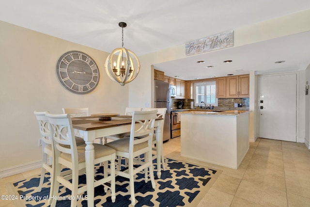 tiled dining space with a chandelier