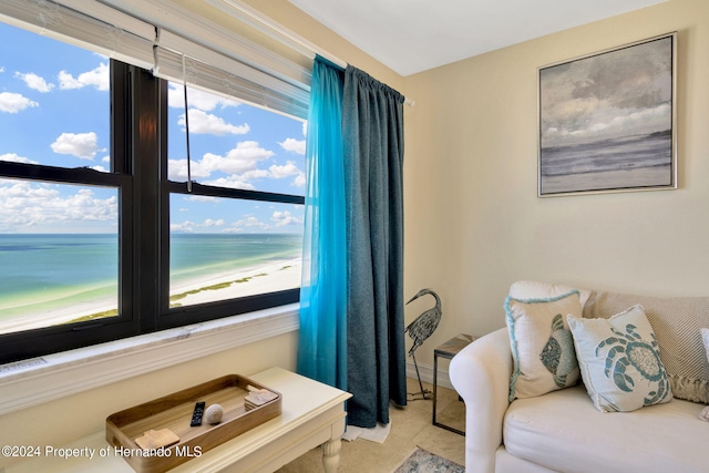 bedroom featuring a view of the beach and a water view