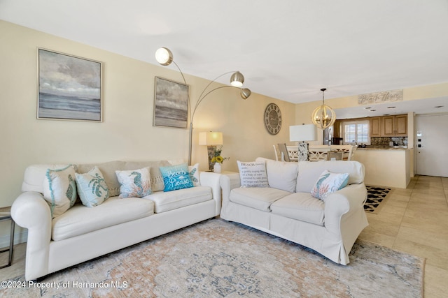 living room featuring a chandelier and light tile patterned floors